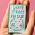 Words "don't stress me out" with stressed cat in mint green. 