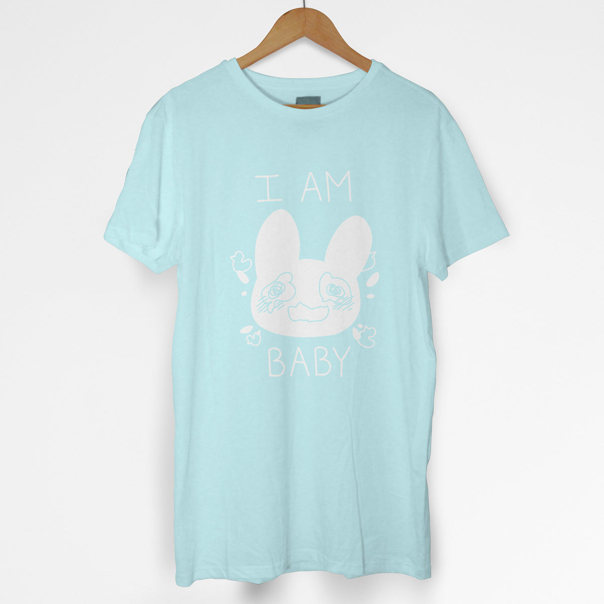 Pastel blue tshirt with crying bunny and text "I am baby" in white.