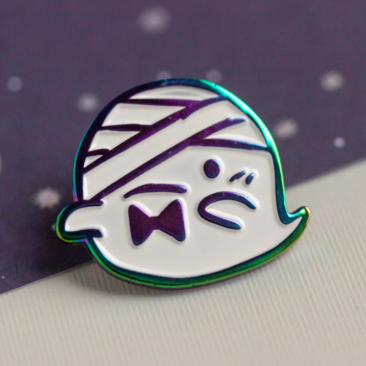 Iridescent ghost with bandaged head and bowtie.