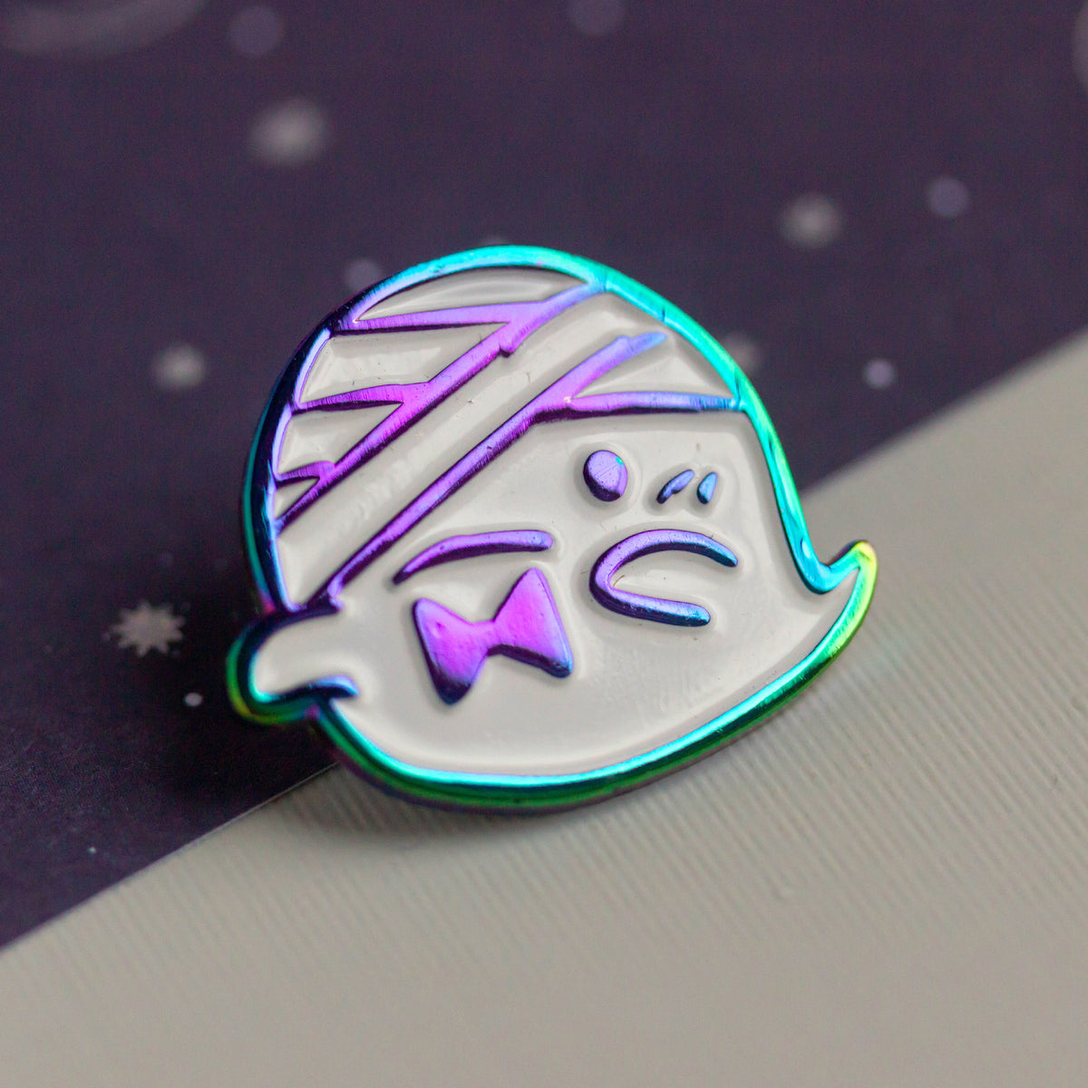 Iridescent ghost with bandaged head and bowtie.