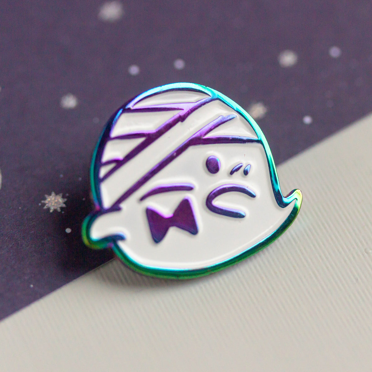 Iridescent ghost with bandaged head and bowtie.