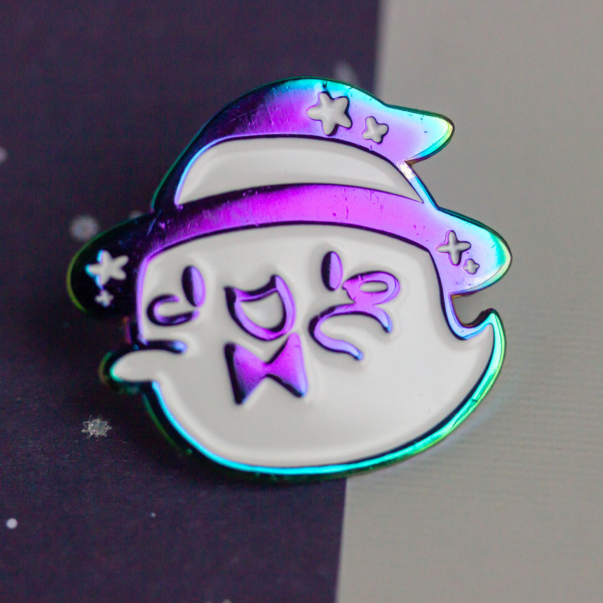 Iridescent ghost with witch hat and bowtie.