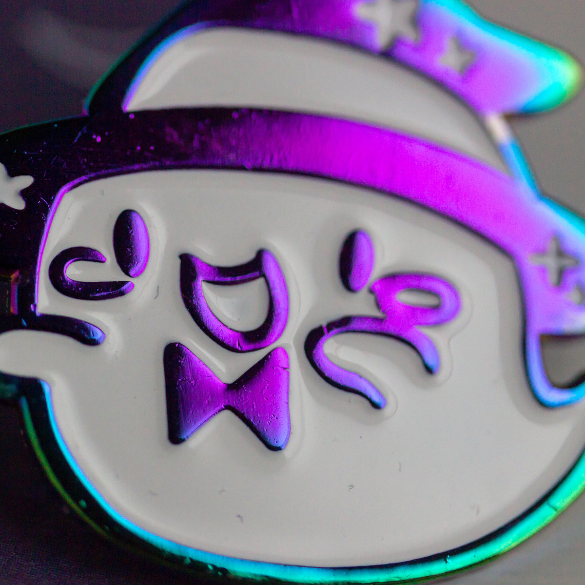 Iridescent ghost with witch hat and bowtie.
