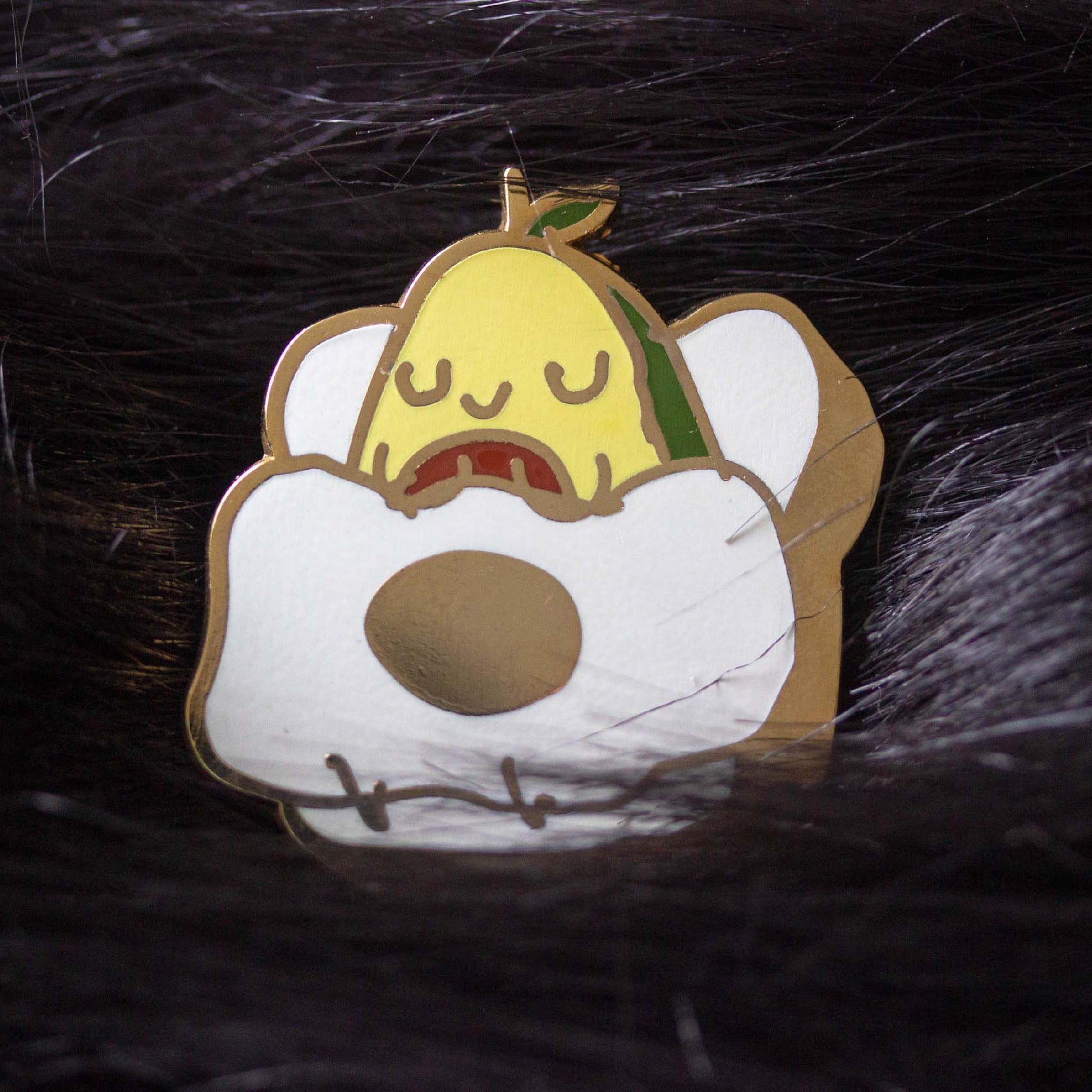 Open avocado sleeping on a piece of toast with a fried egg blanket.